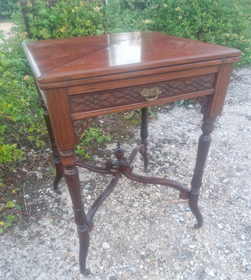 Edwardian mahogany envelope games table stamped Maples.