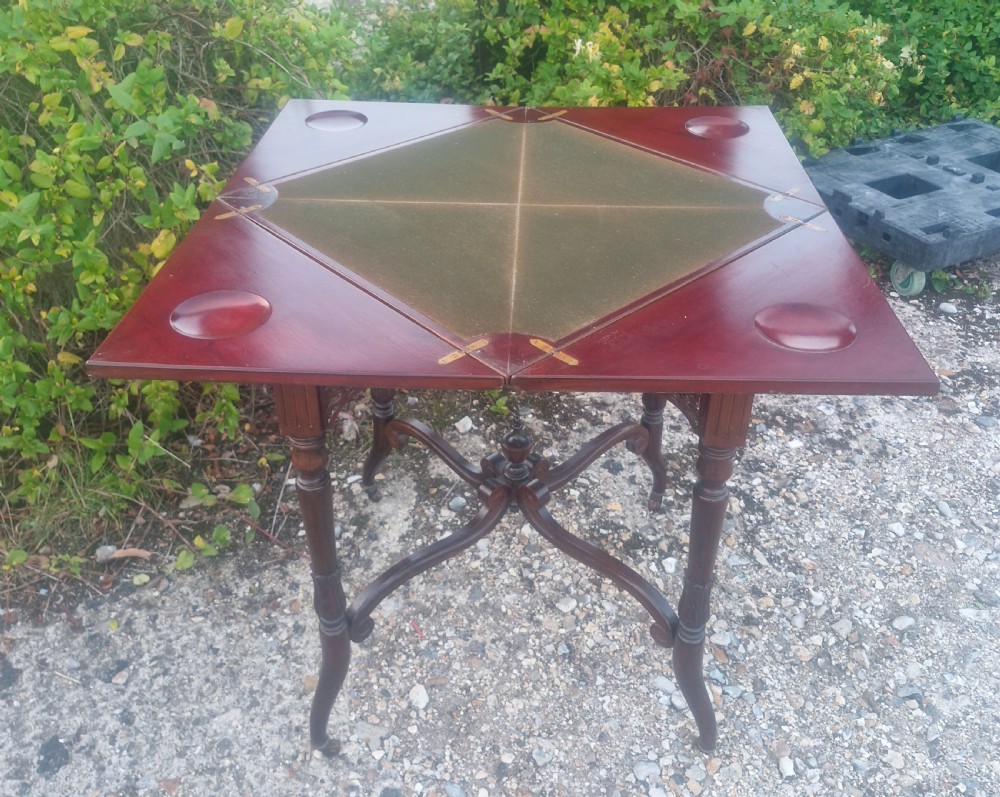 Edwardian mahogany envelope games table stamped Maples. View II
