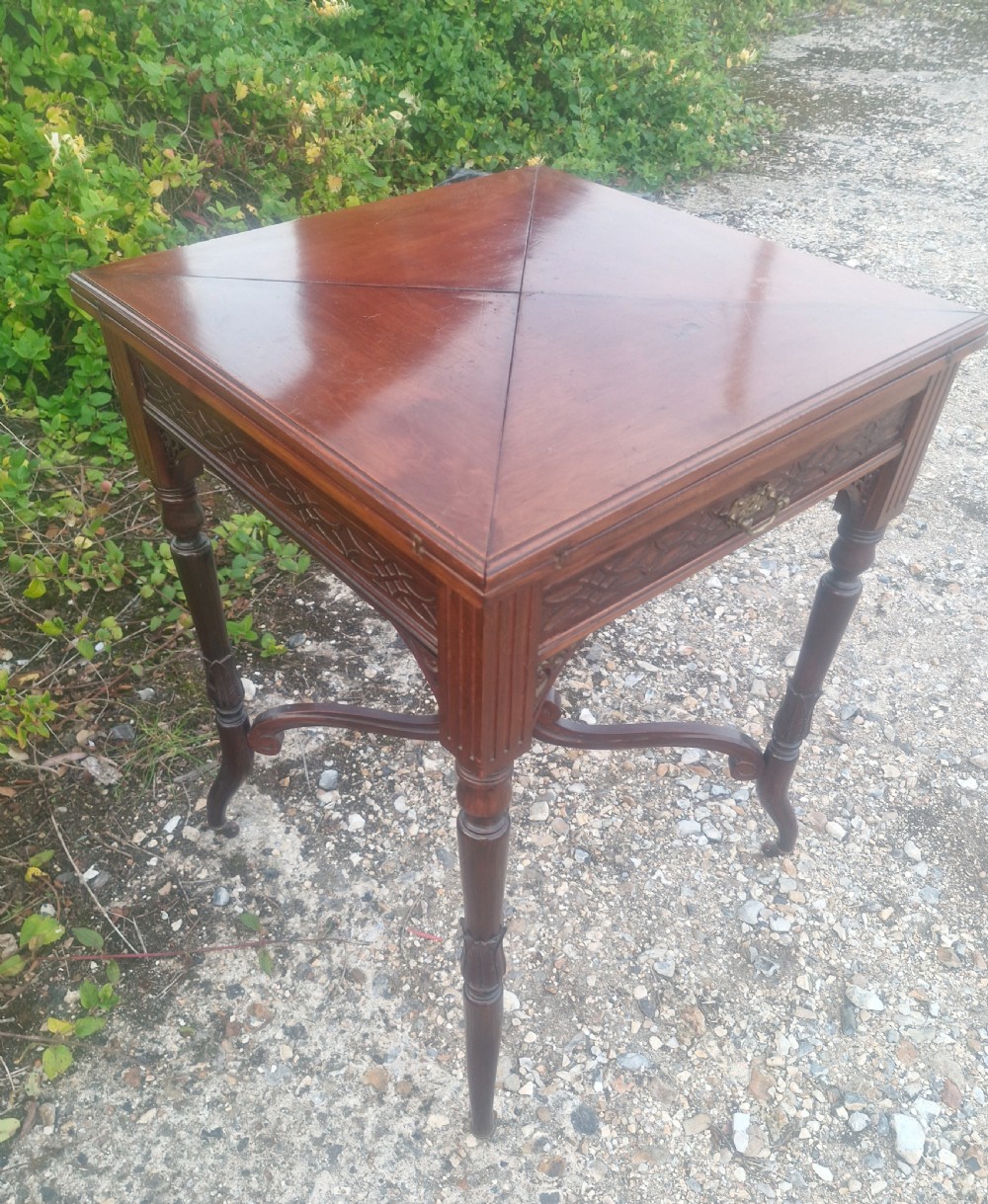 Edwardian mahogany envelope games table stamped Maples. View VIII