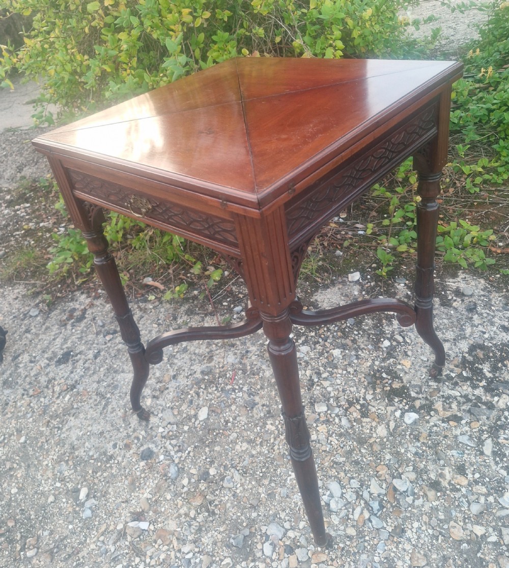 Edwardian mahogany envelope games table stamped Maples. View IX