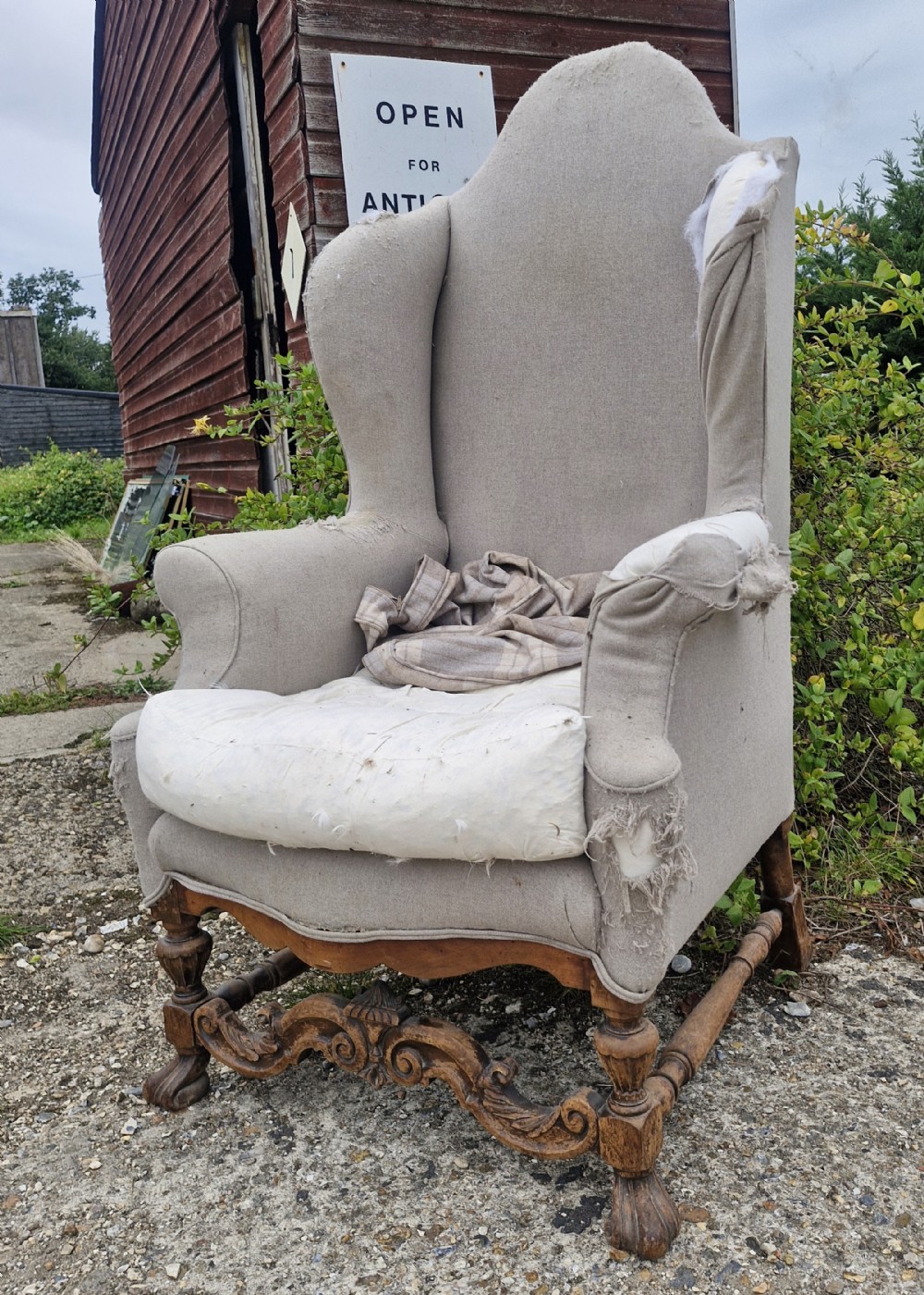 Tall wing back upholstered armchair for recovering. 