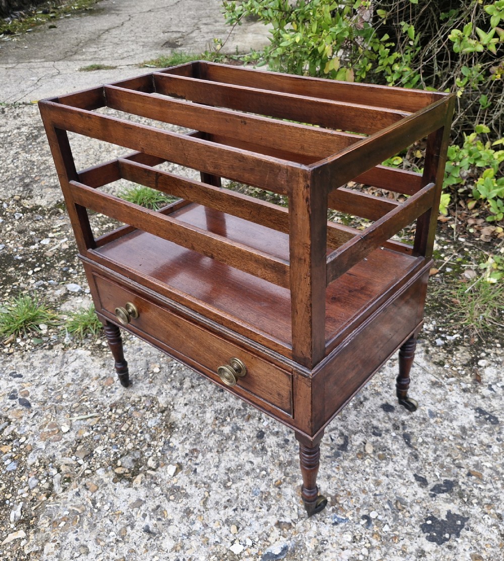 A Regency mahogany music Canterbury featuring slotted upper dividers, a single lower drawer with brass knobs, and turned legs with brass castors. View VIII