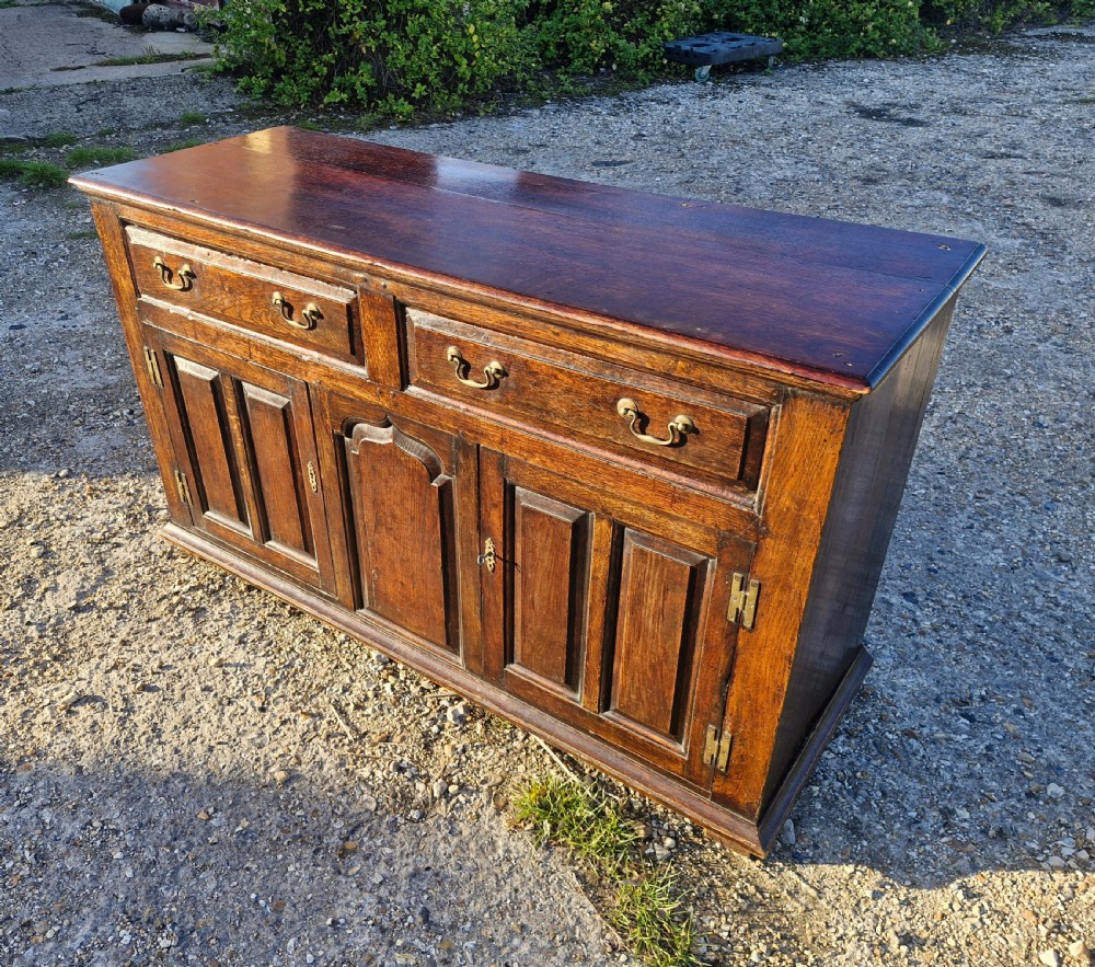 Antique panelled oak dresser base. 