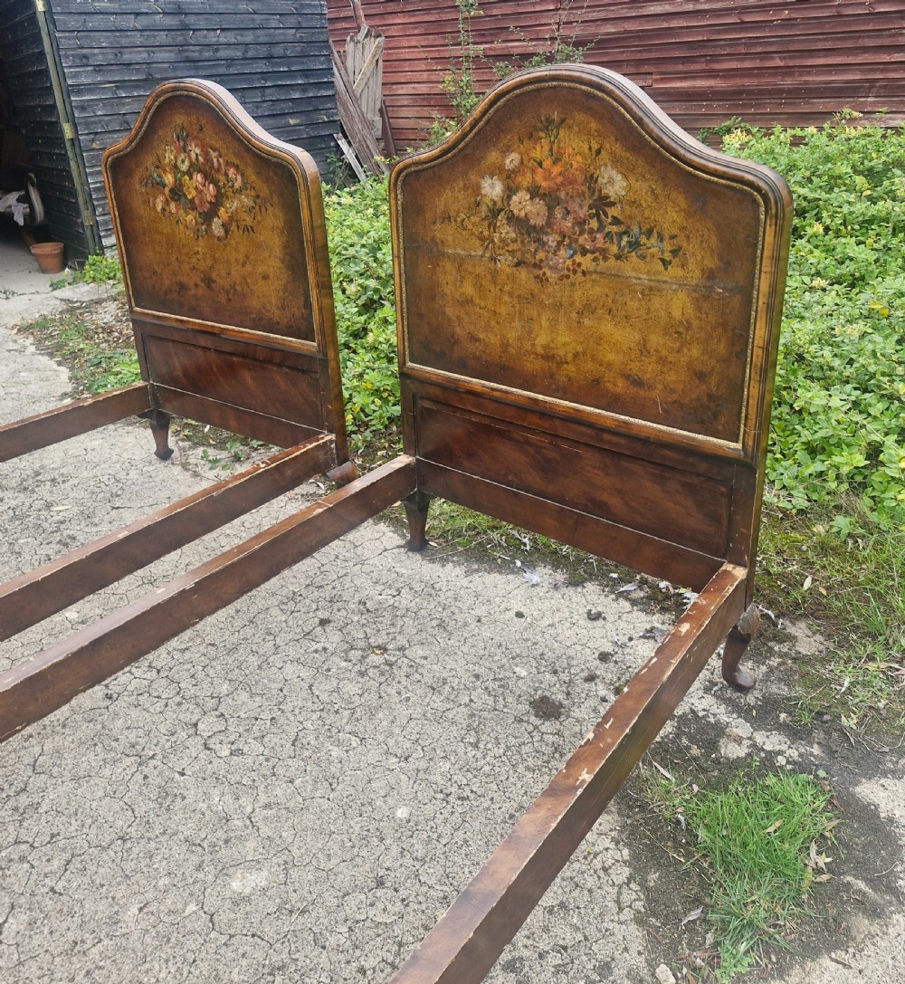 A pair of antique walnut single bed frames featuring arched headboards with floral painted leather panels and scrolled footboard posts. View VIII