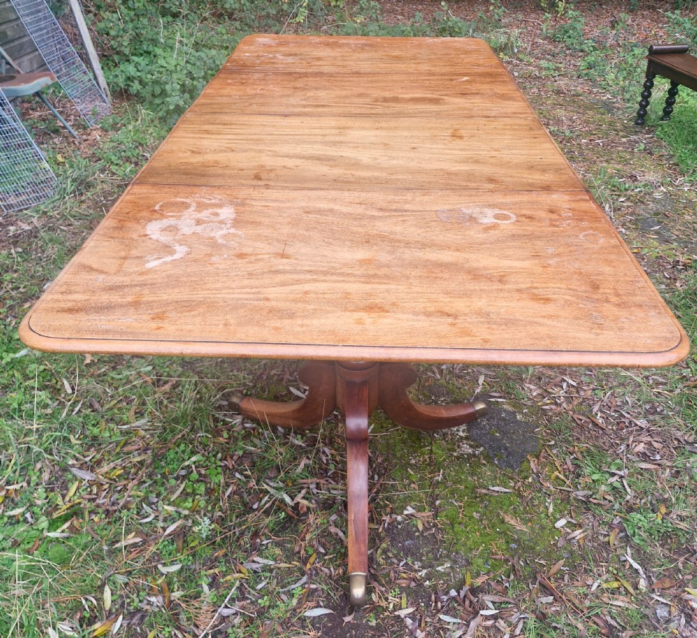 Regency mahogany twin pillar dining table with 2 extra leaves.