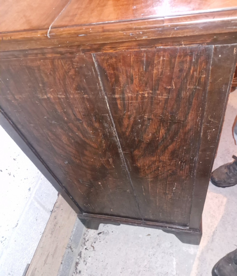 An 18th-century walnut chest of drawers featuring three small top drawers above three long drawers with brass drop handles and bracket feet. View III