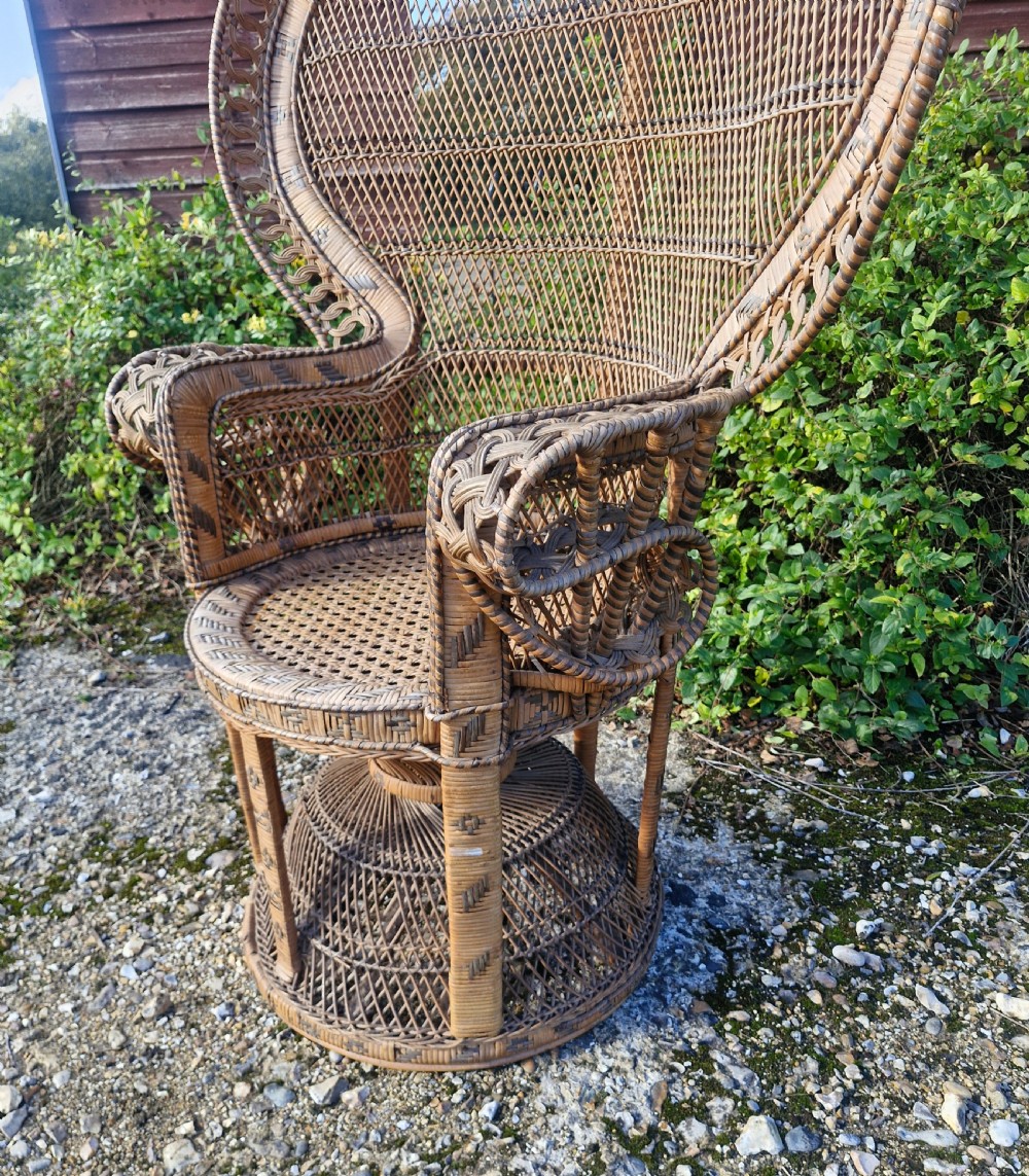A high-backed woven cane peacock armchair featuring a flared fan backrest with lattice weaving, integrated armrests, and an hourglass pedestal base. View XI