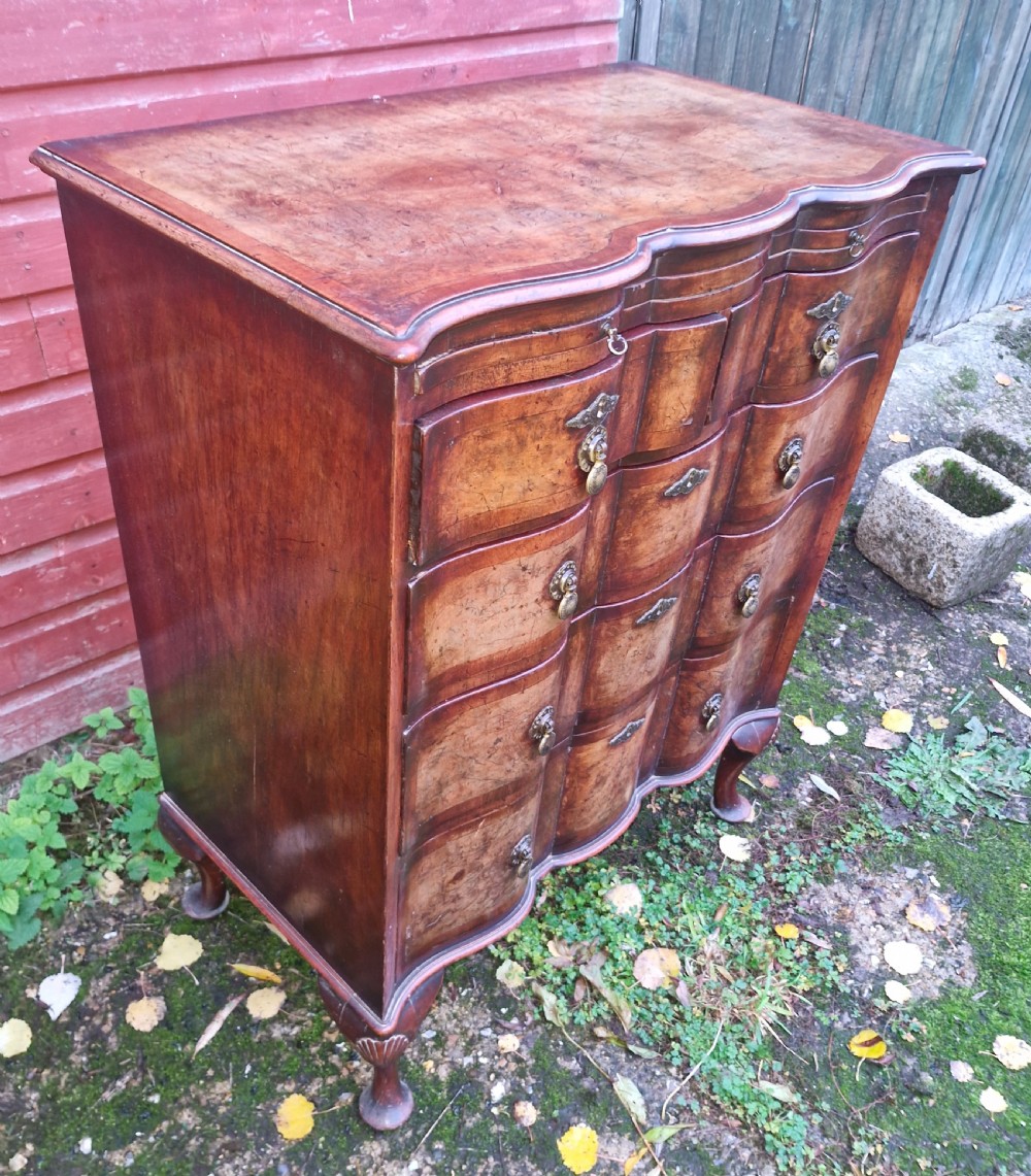 Early 20th century walnut serpentine front chest with brushing slide.  View VII