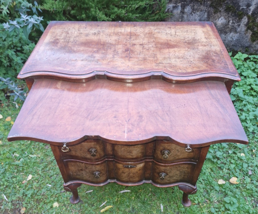 Early 20th century walnut serpentine front chest with brushing slide.  View IX