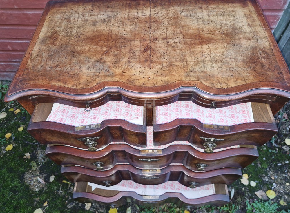 Early 20th century walnut serpentine front chest with brushing slide.  View X