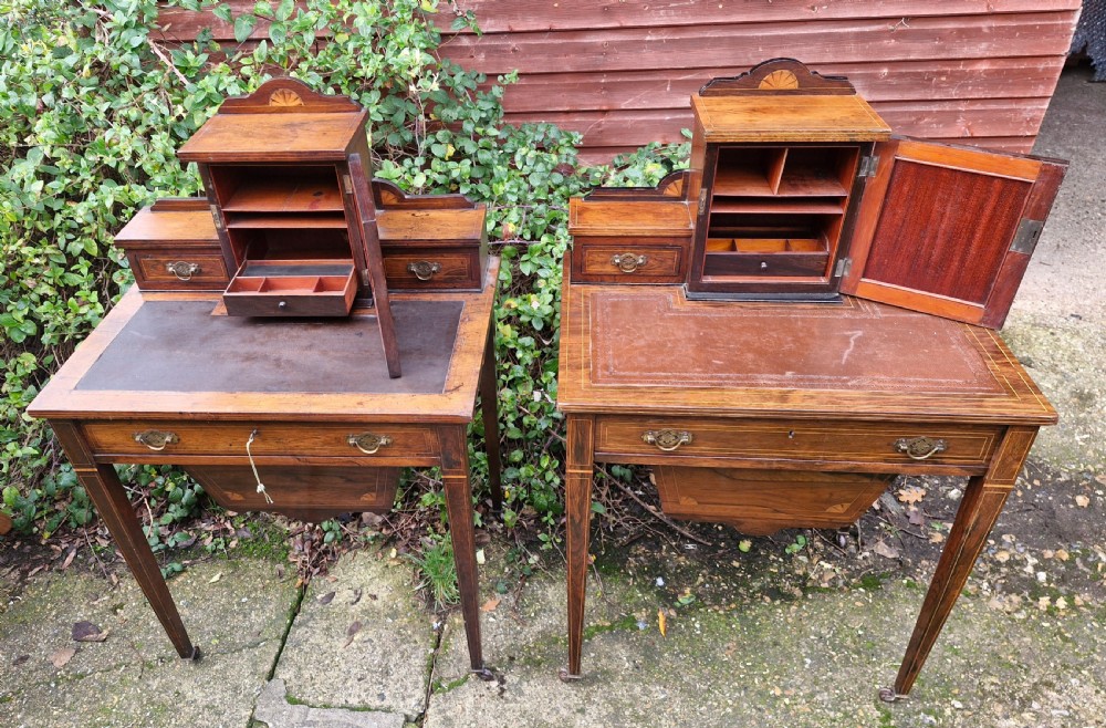 A pair of late Victorian rosewood writing tables featuring central raised cupboards with urn inlay, leather surfaces, and tapered square legs. View III
