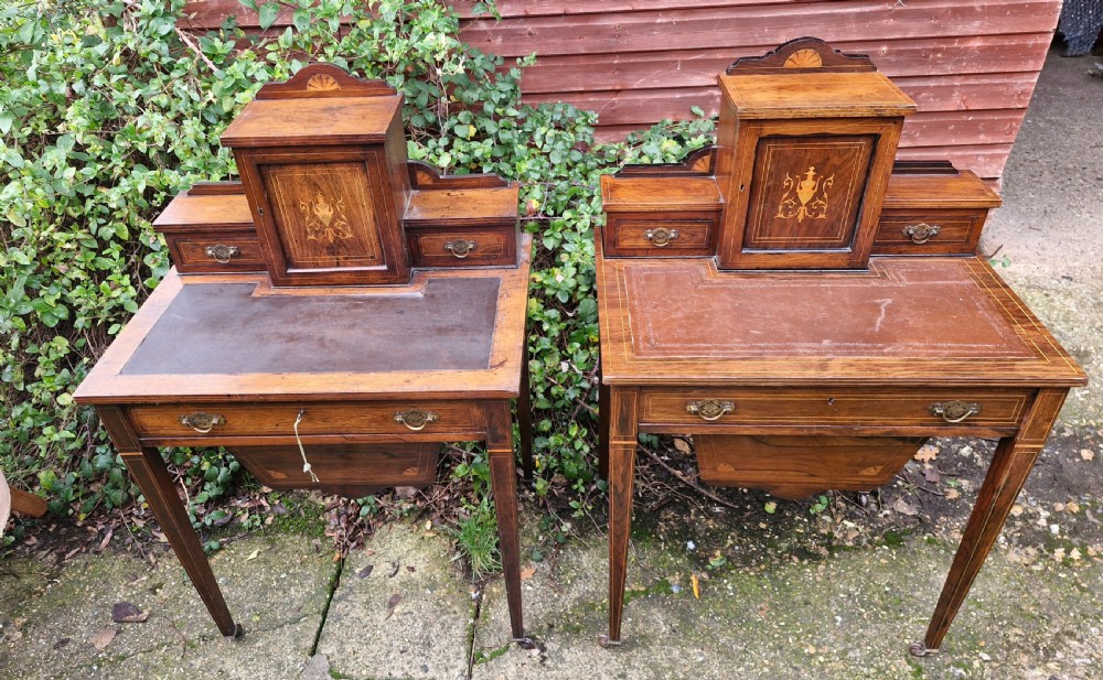 A pair of late Victorian rosewood writing tables featuring central raised cupboards with urn inlay, leather surfaces, and tapered square legs. View VII
