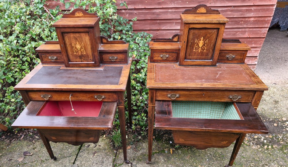 A pair of late Victorian rosewood writing tables featuring central raised cupboards with urn inlay, leather surfaces, and tapered square legs. View VIII