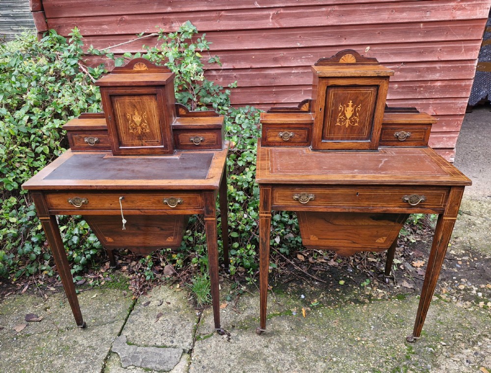 A pair of late Victorian rosewood writing tables featuring central raised cupboards with urn inlay, leather surfaces, and tapered square legs. View IX