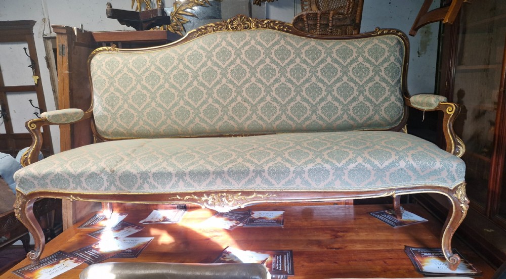 Carved and gilt heightened open arm sofa. View II