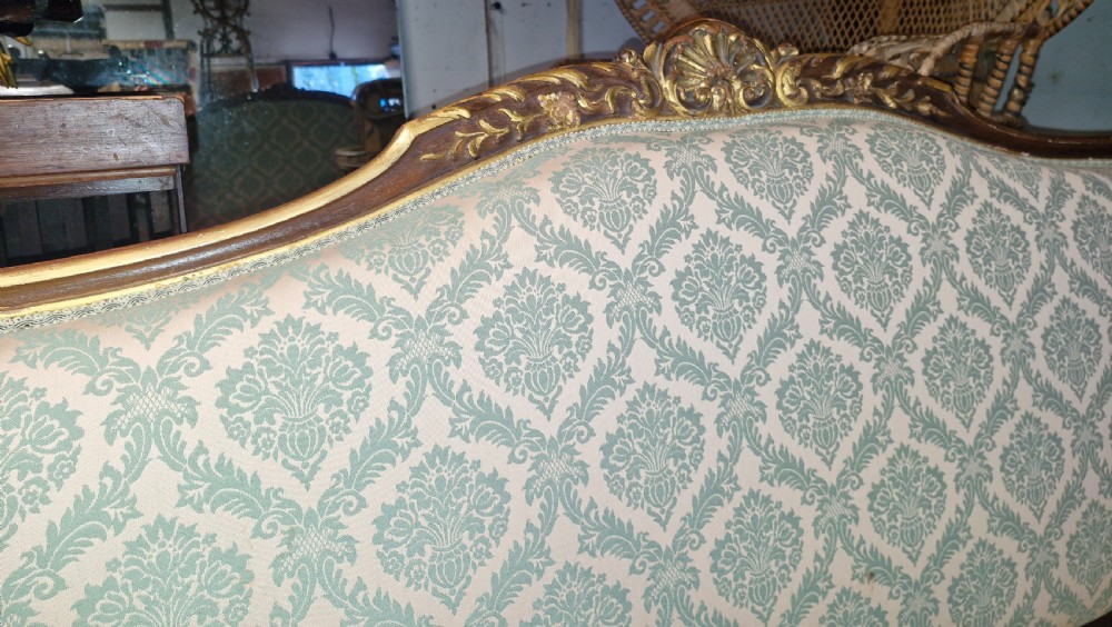 Carved and gilt heightened open arm sofa. View V