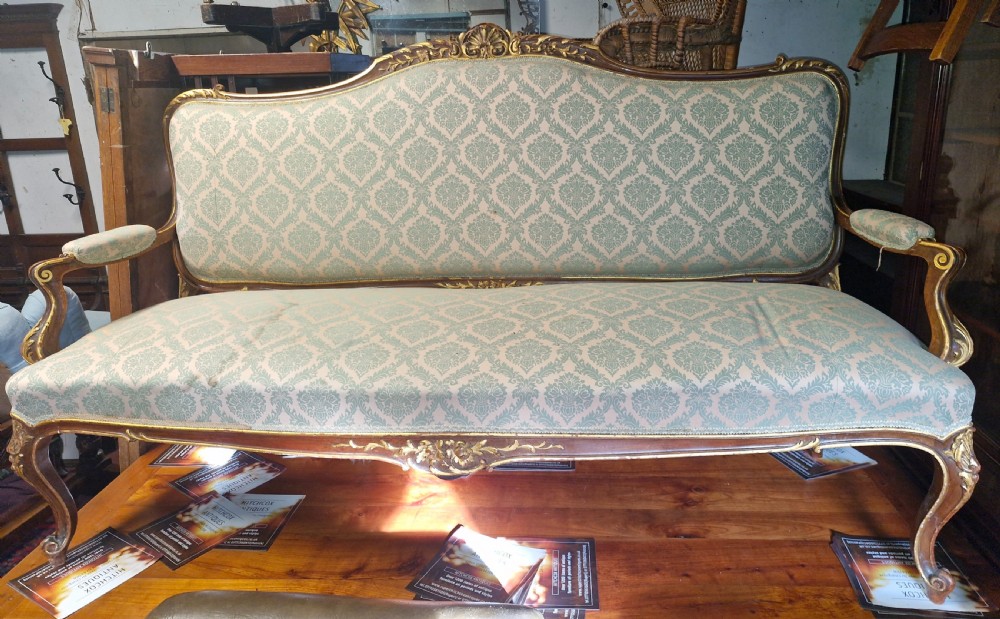 Carved and gilt heightened open arm sofa. View VII