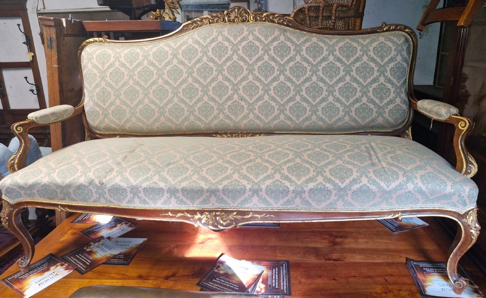 Carved and gilt heightened open arm sofa. View IX