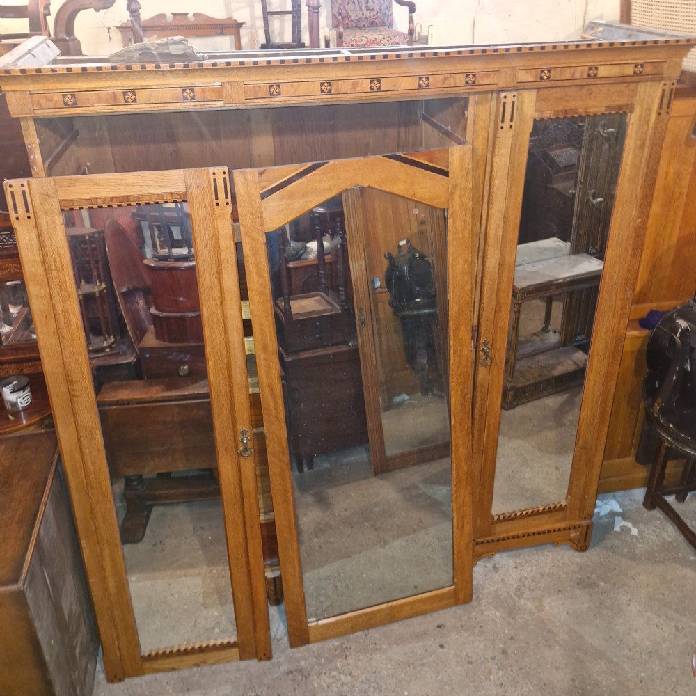 Victorian inlaid oak triple mirror door wardrobe in the manner of Charles Bevan.