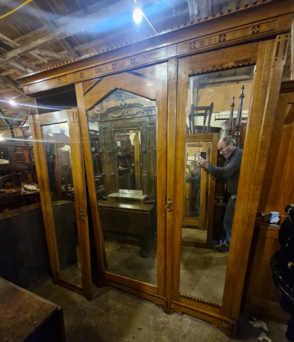 Victorian inlaid oak triple mirror door wardrobe in the manner of Charles Bevan. View II