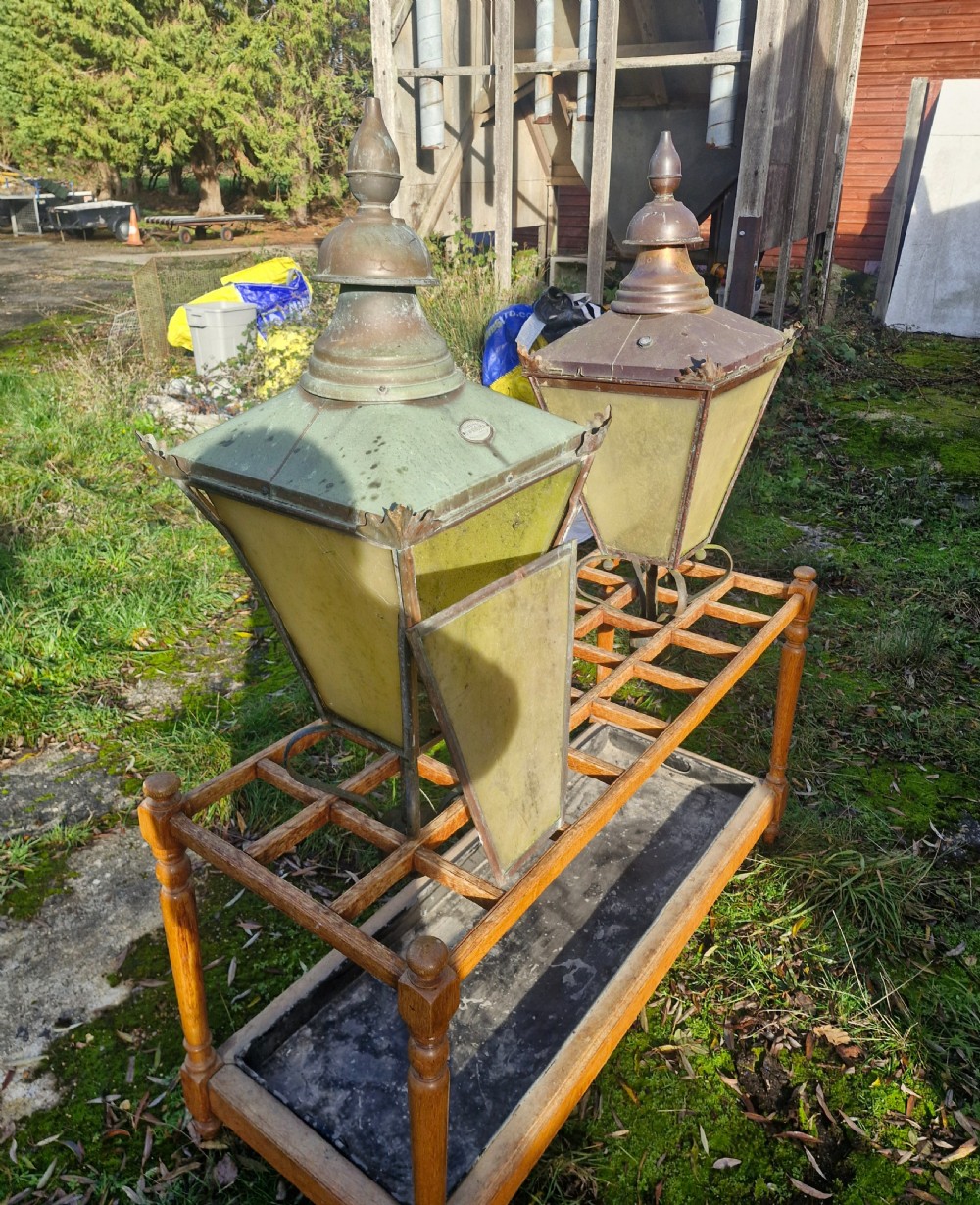 A pair of antique copper street lantern tops featuring tapered glazed panels, decorative finials, and scrolled iron mounts. View XIII