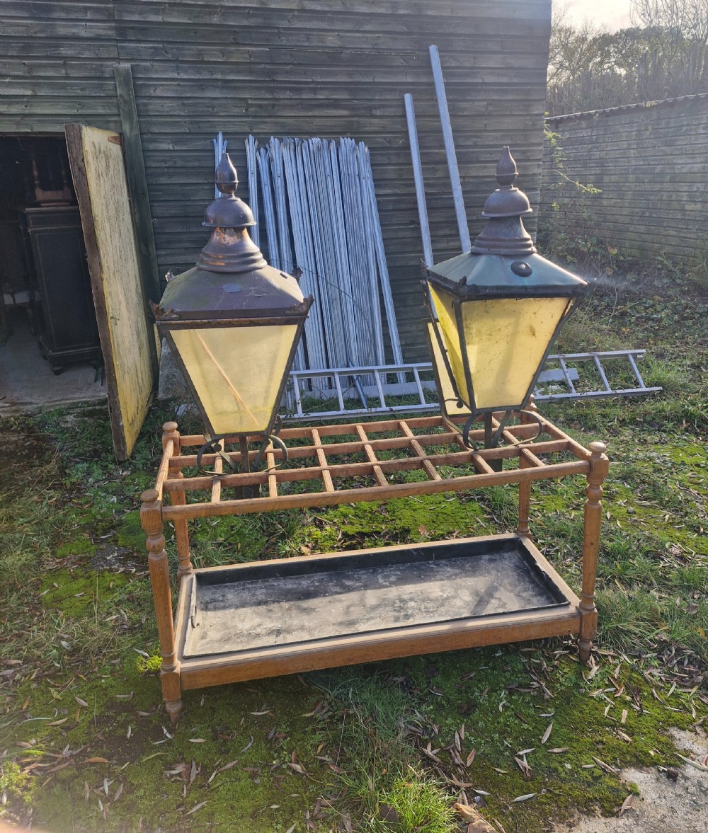 A pair of antique copper street lantern tops featuring tapered glazed panels, decorative finials, and scrolled iron mounts. View XVII