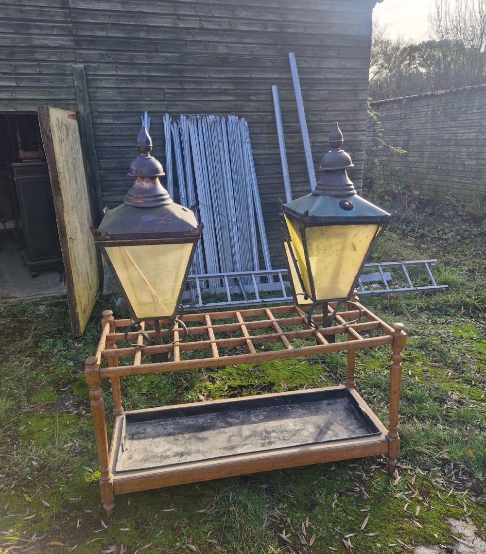 A pair of antique copper street lantern tops featuring tapered glazed panels, decorative finials, and scrolled iron mounts. View XVIII