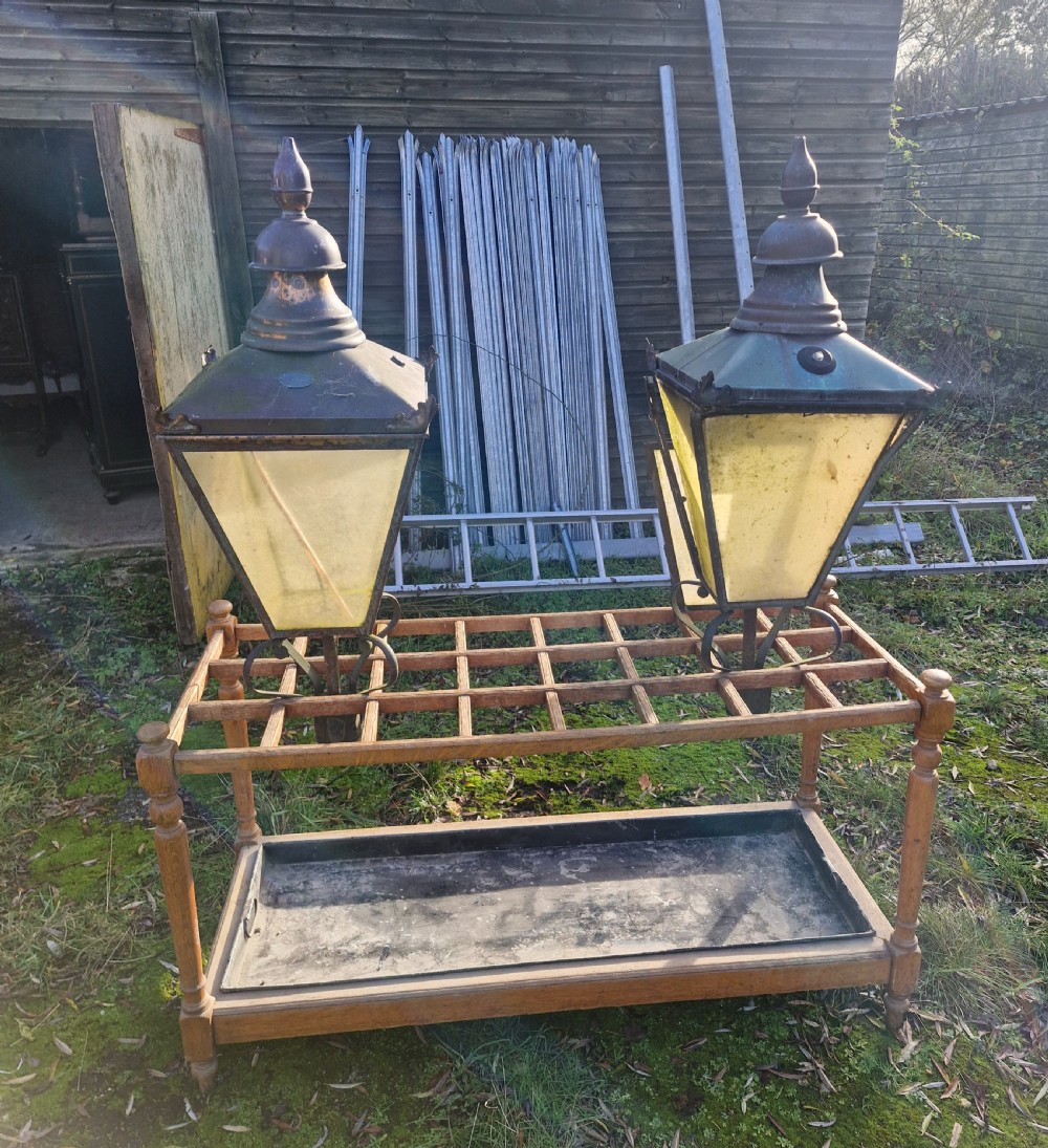 A pair of antique copper street lantern tops featuring tapered glazed panels, decorative finials, and scrolled iron mounts. View XIX