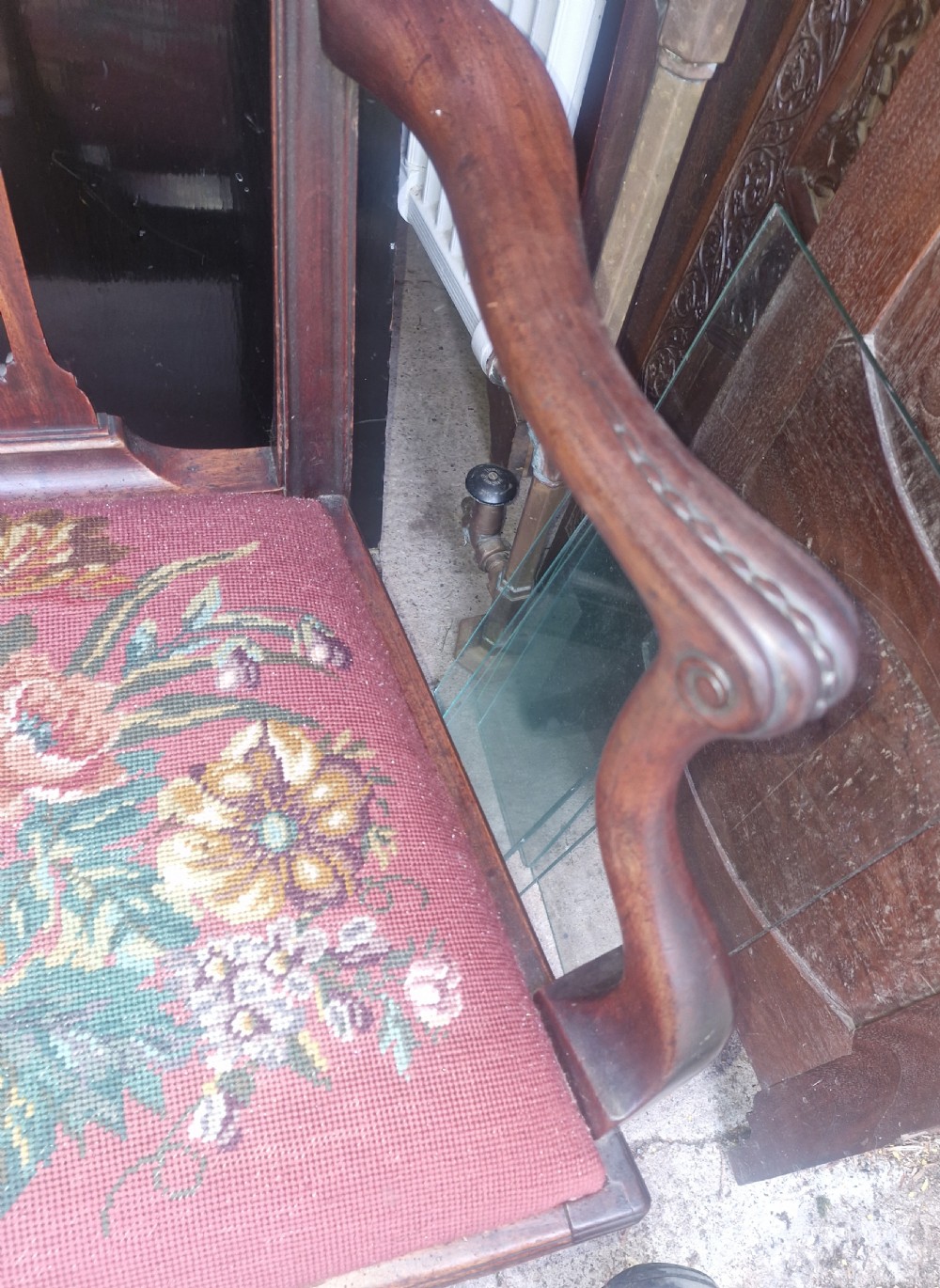 An early 19th-century mahogany desk armchair with a carved pierced splat back, shaped armrests, and a floral needlepoint upholstered seat. View III