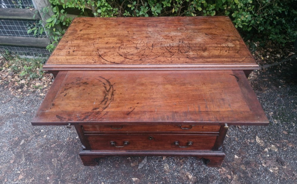 A Georgian mahogany bachelors chest featuring four drawers, a pull-out brushing slide, brass swan-neck handles, and bracket feet. View II