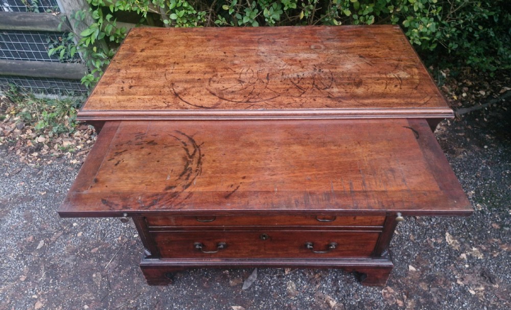 A Georgian mahogany bachelors chest featuring four drawers, a pull-out brushing slide, brass swan-neck handles, and bracket feet. View III