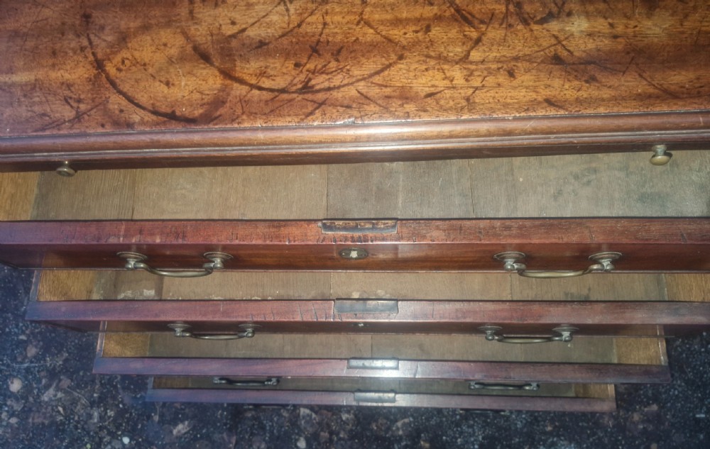 A Georgian mahogany bachelors chest featuring four drawers, a pull-out brushing slide, brass swan-neck handles, and bracket feet. View VII