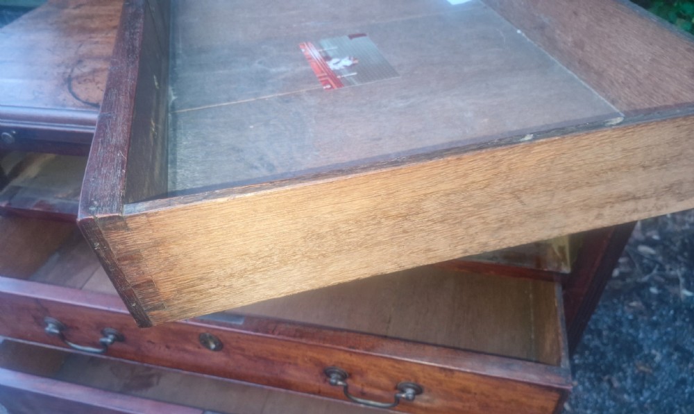 A Georgian mahogany bachelors chest featuring four drawers, a pull-out brushing slide, brass swan-neck handles, and bracket feet. View VIII