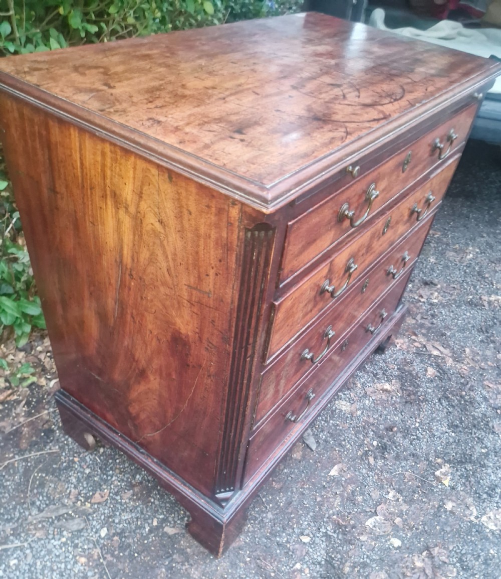 A Georgian mahogany bachelors chest featuring four drawers, a pull-out brushing slide, brass swan-neck handles, and bracket feet. View XI