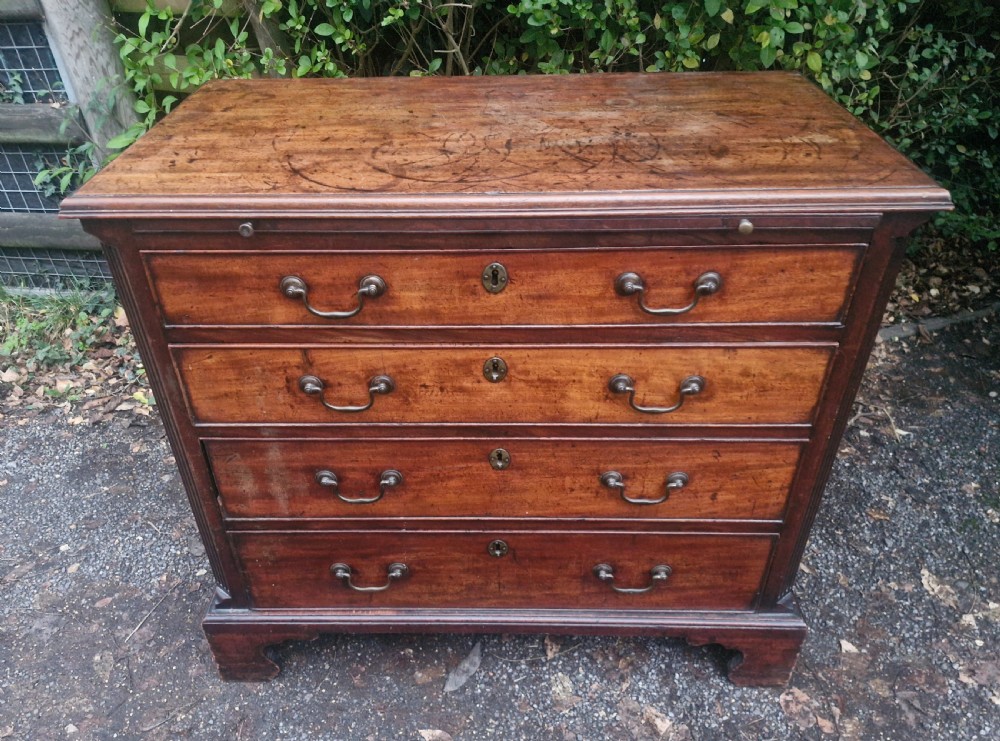 A Georgian mahogany bachelors chest featuring four drawers, a pull-out brushing slide, brass swan-neck handles, and bracket feet. View XIII
