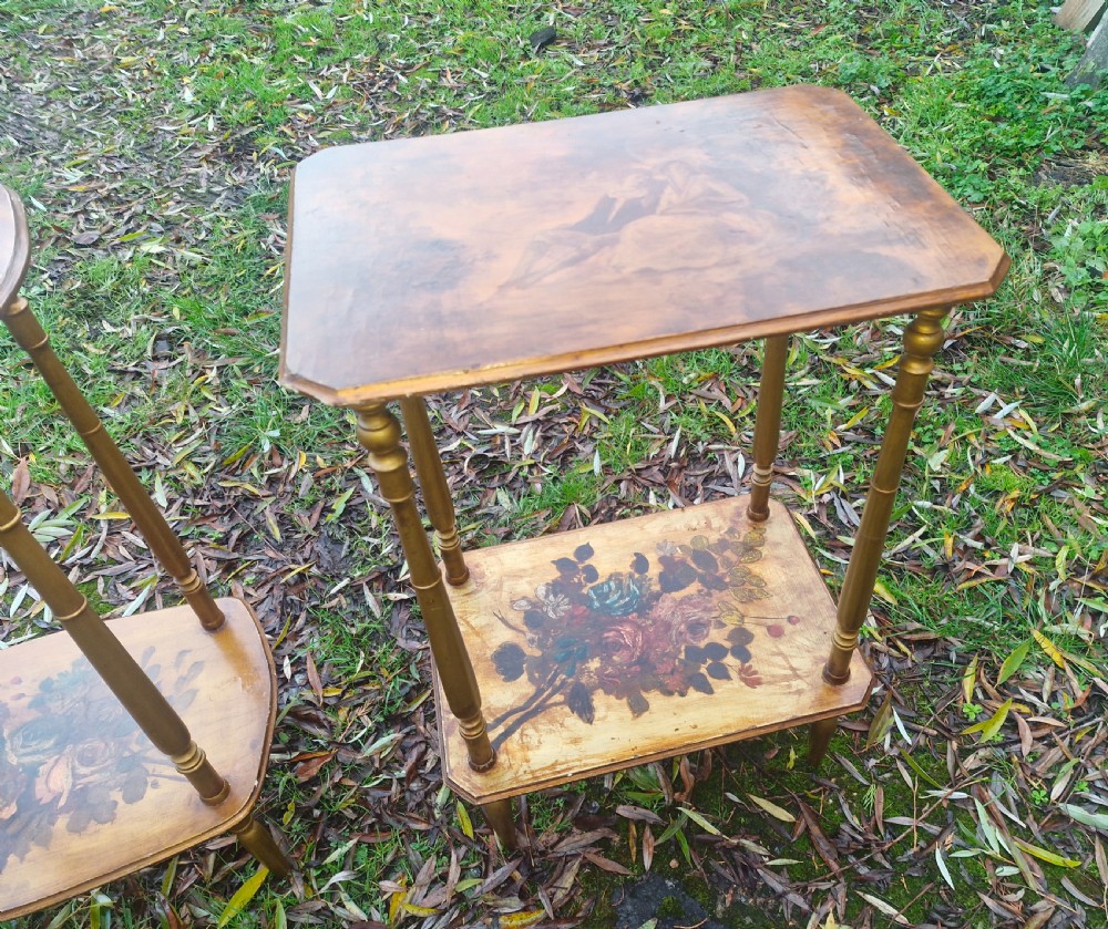 A pair of two-tier rectangular occasional tables featuring gold-painted turned legs, painted figurative scenes on the top surfaces, and floral artwork on the lower shelves. View III