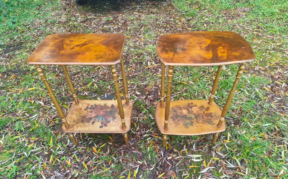 A pair of two-tier rectangular occasional tables featuring gold-painted turned legs, painted figurative scenes on the top surfaces, and floral artwork on the lower shelves. View VI