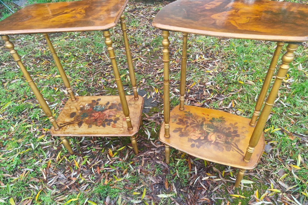 A pair of two-tier rectangular occasional tables featuring gold-painted turned legs, painted figurative scenes on the top surfaces, and floral artwork on the lower shelves. View VII