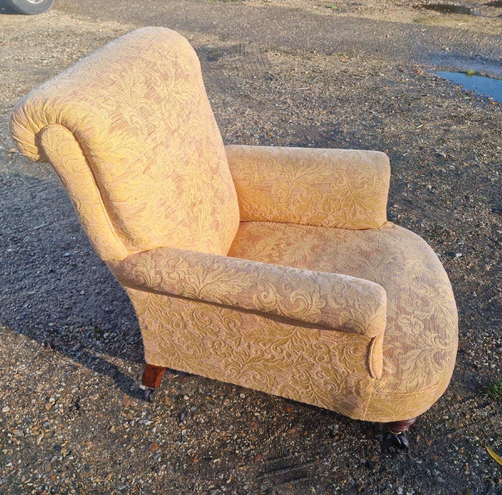 Late Victorian upholstered armchair in the style of Howard. 