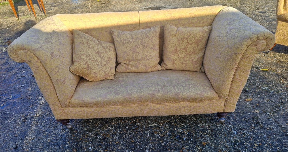 Late Victorian upholstered 2 seater sofa in the style of Howard. 