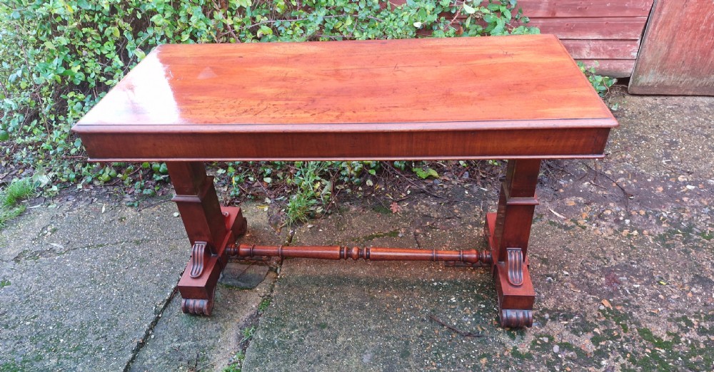 A tiered mid Victorian adjustable dumb waiter crafted from polished mahogany with scrolled feet. View II