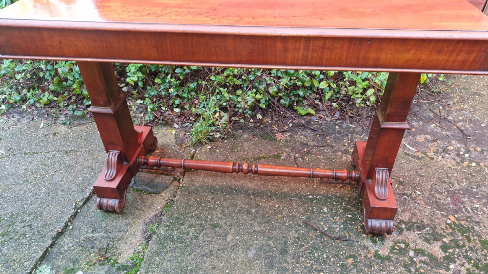 A tiered mid Victorian adjustable dumb waiter crafted from polished mahogany with scrolled feet. View III