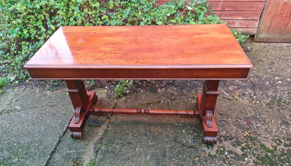 A tiered mid Victorian adjustable dumb waiter crafted from polished mahogany with scrolled feet. View IV