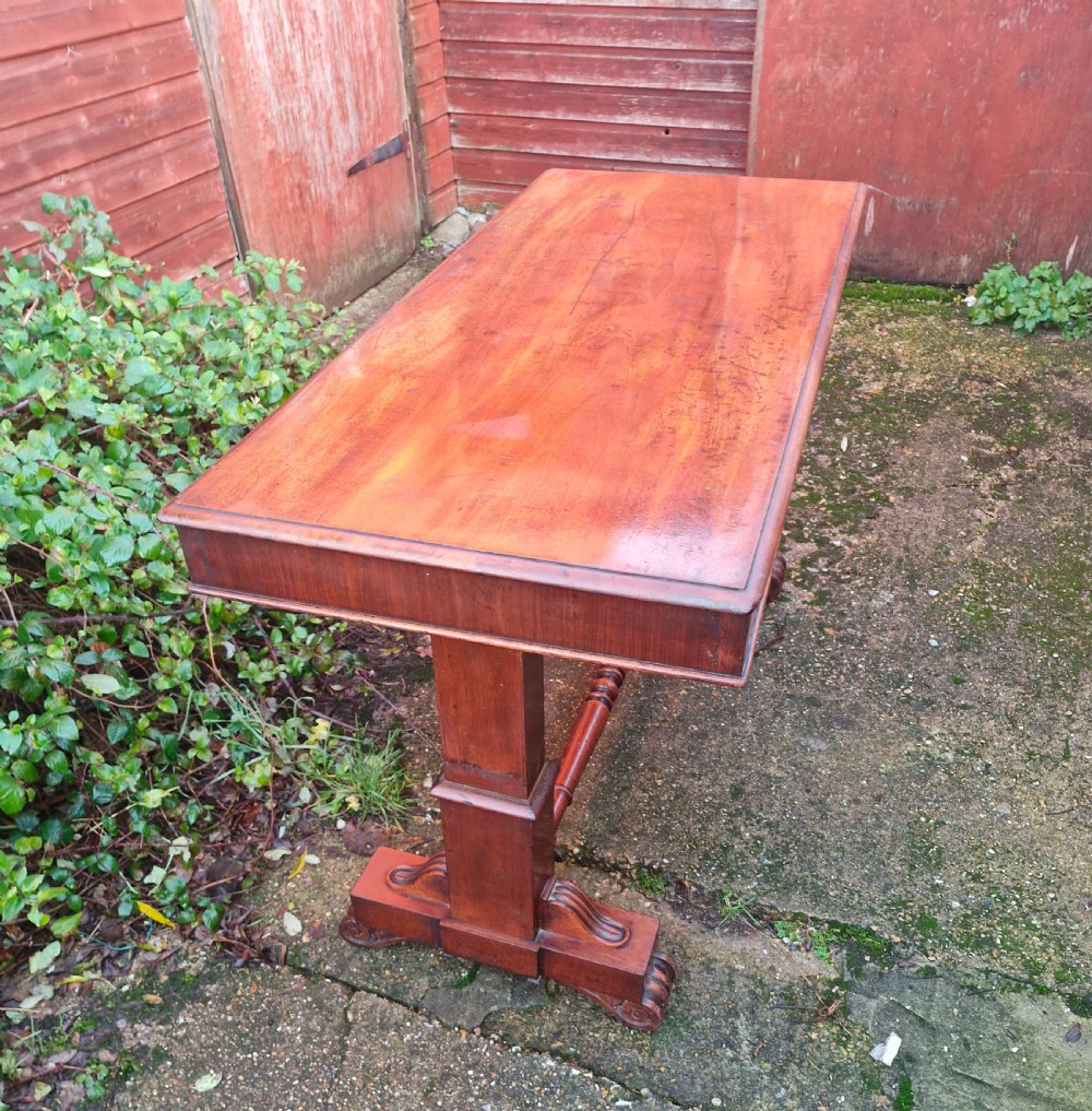 A tiered mid Victorian adjustable dumb waiter crafted from polished mahogany with scrolled feet. View V