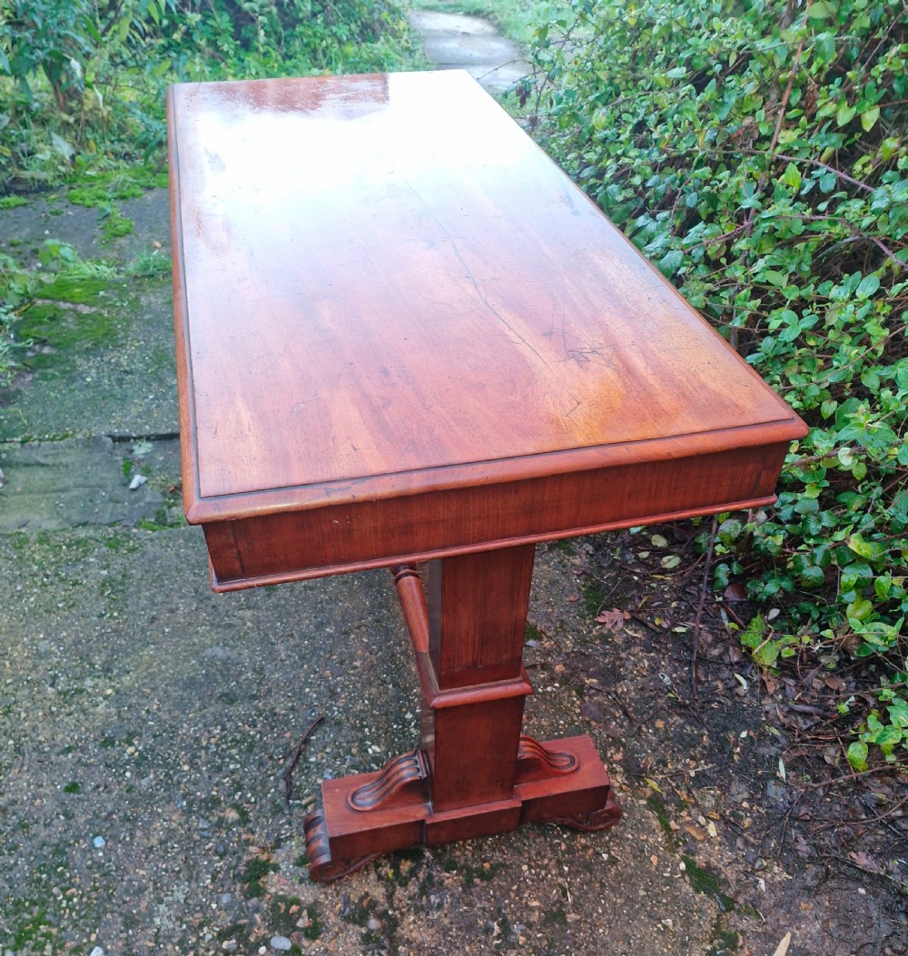 A tiered mid Victorian adjustable dumb waiter crafted from polished mahogany with scrolled feet. View VI