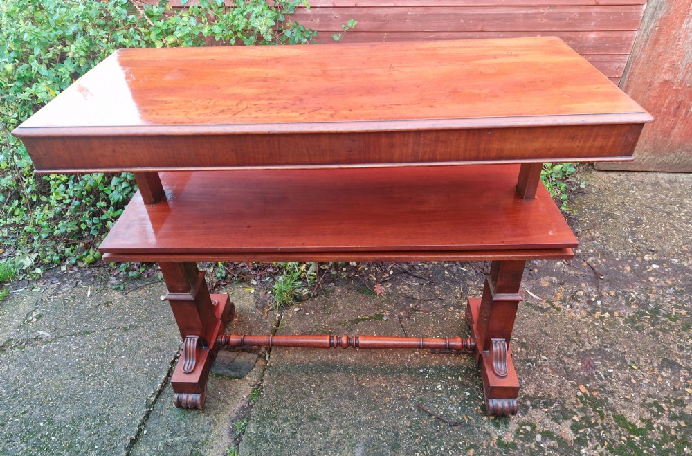 A tiered mid Victorian adjustable dumb waiter crafted from polished mahogany with scrolled feet. View VII