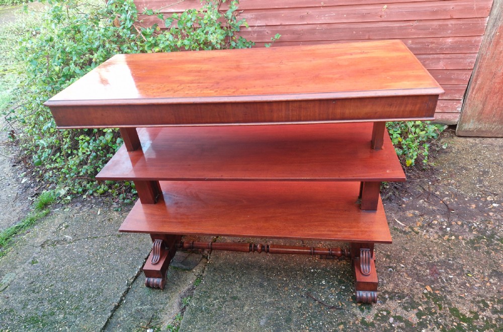 A tiered mid Victorian adjustable dumb waiter crafted from polished mahogany with scrolled feet. View VIII