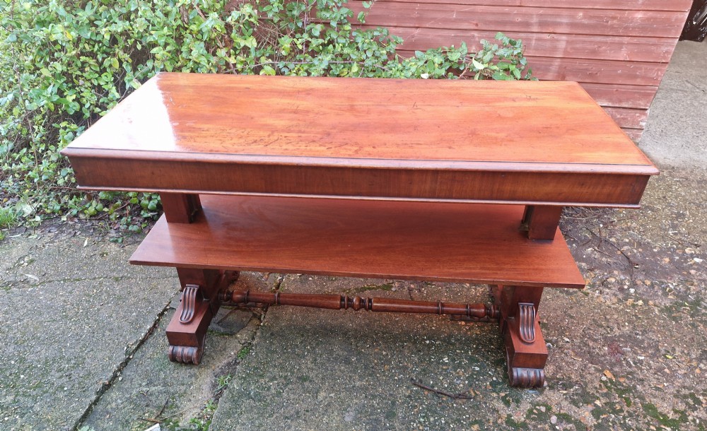 A tiered mid Victorian adjustable dumb waiter crafted from polished mahogany with scrolled feet. View X