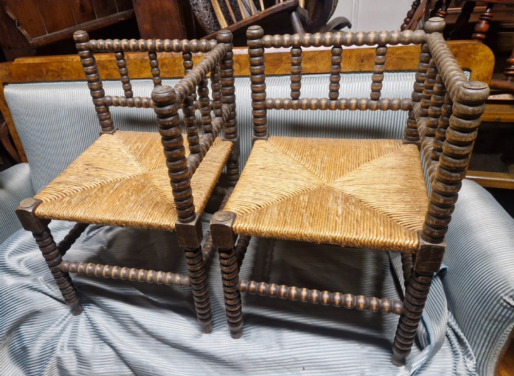 Pair of Bobbin framed rush seat corner chairs.
