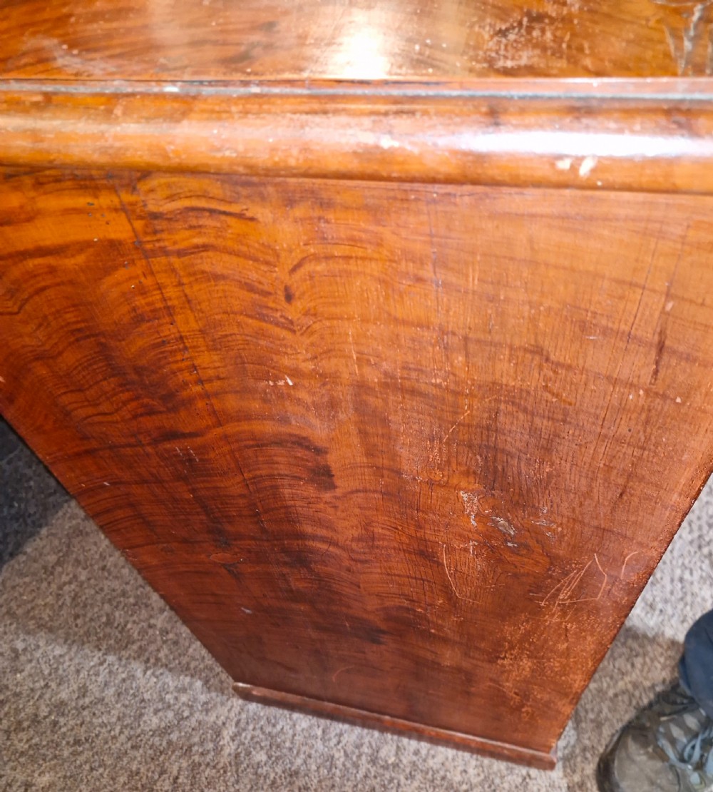 A Victorian pine chest of drawers featuring a warm brown scumbled faux-grain painted finish, two short drawers over three long drawers, and white turned handles. View III